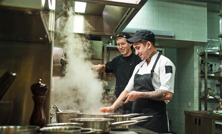 two chefs in a kitchen