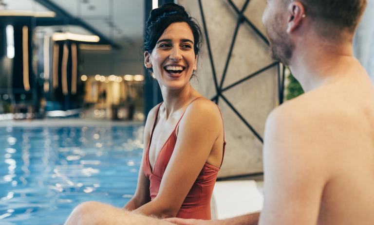 A couple having fun by the pool