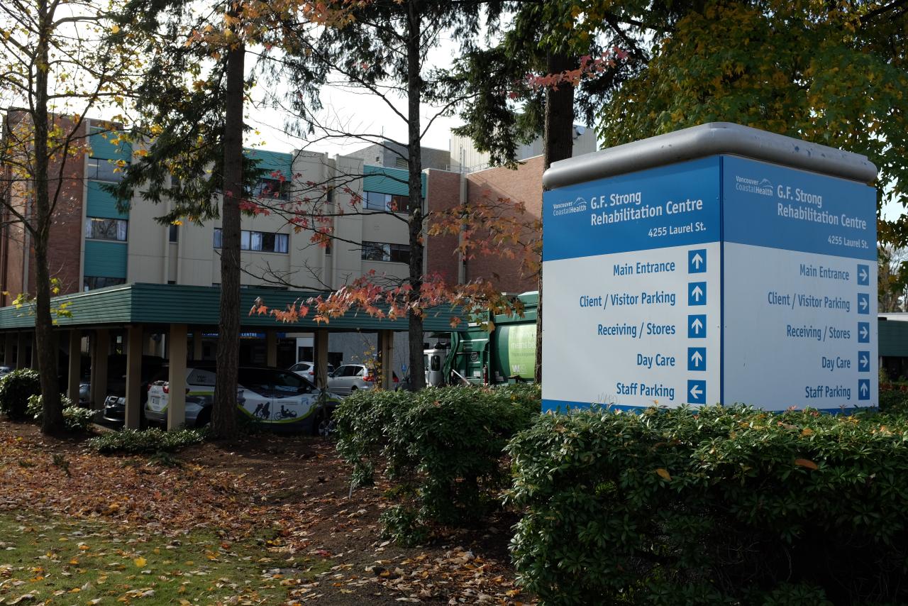 Exterior of G.F. Strong Rehabilitation Centre with wayfinding sign in the foreground