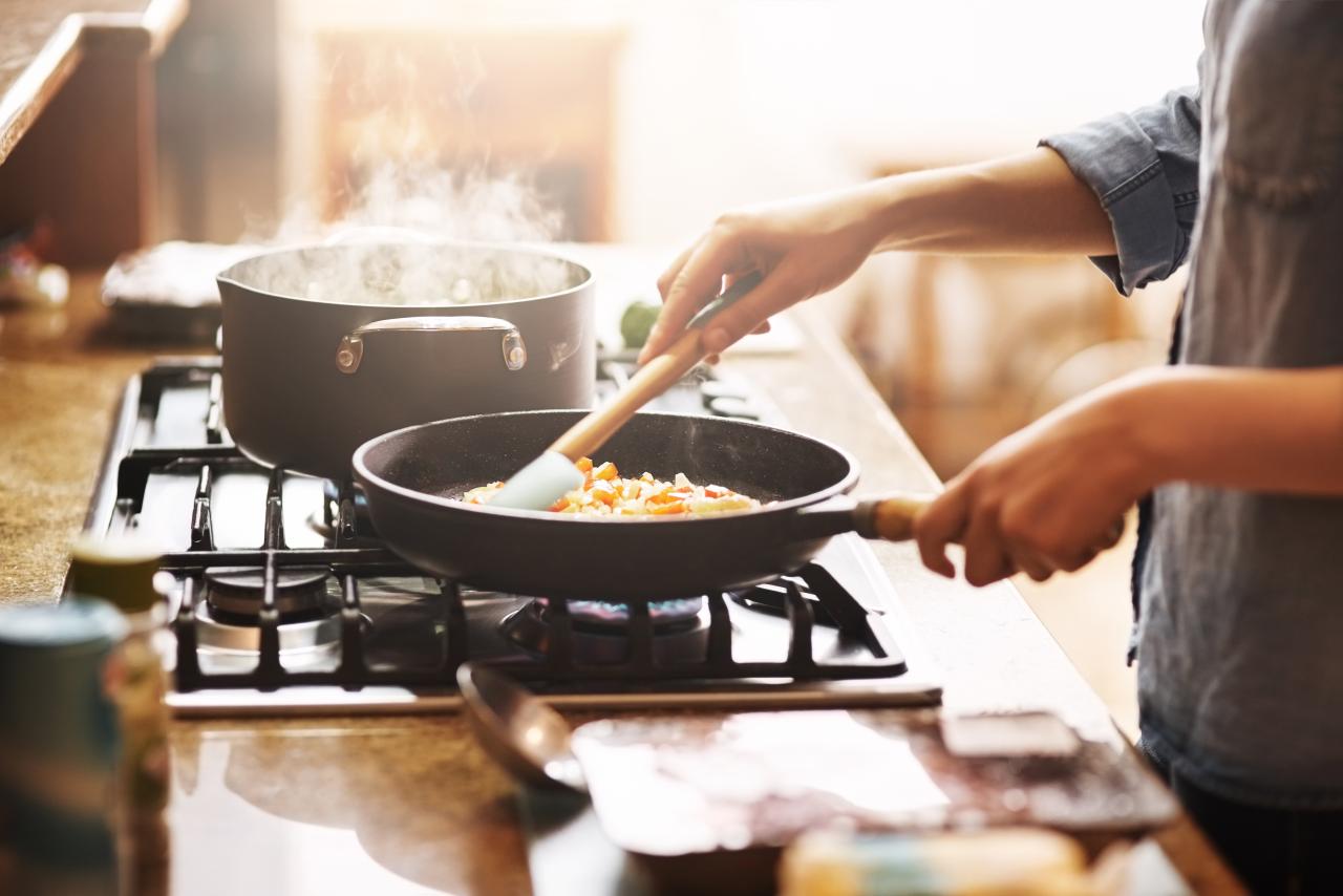 Cropped shot of a young person preparing a meal at home