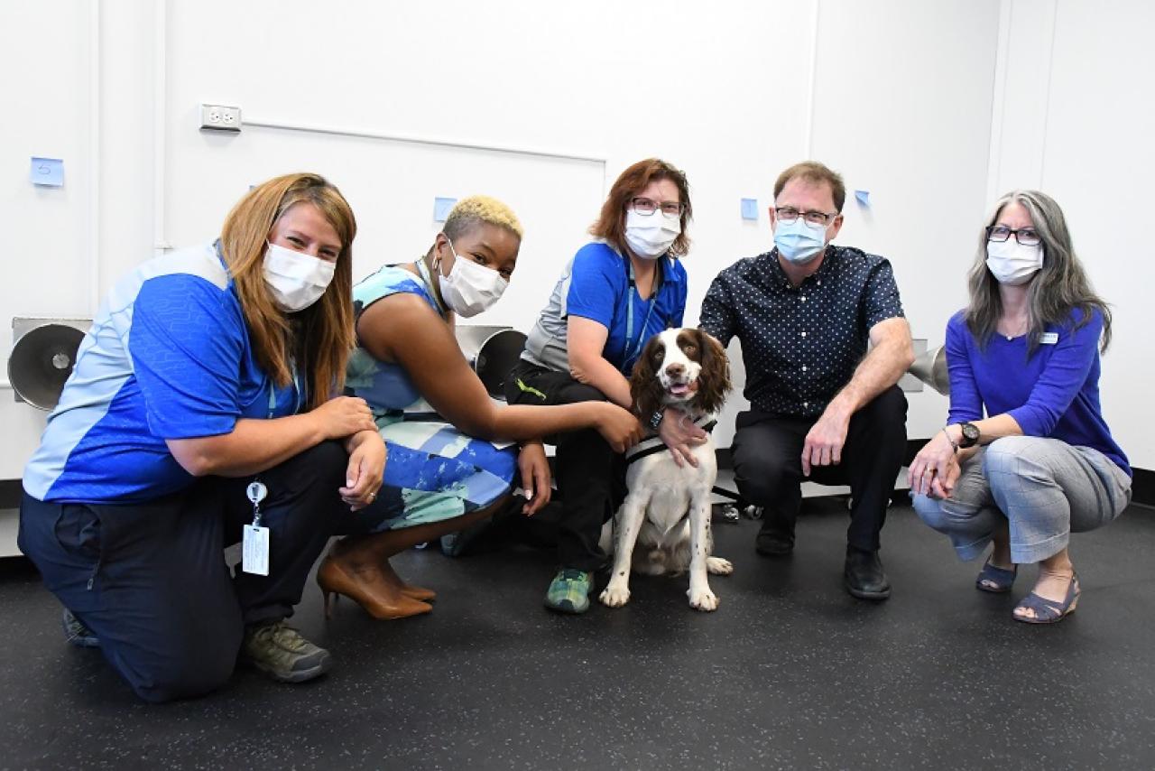 Left to right: Lale Aksu, Dr. Marthe Charles, Teresa Zurberg, Hon. Adrian Dix, Michelle de Moor with canine Finn