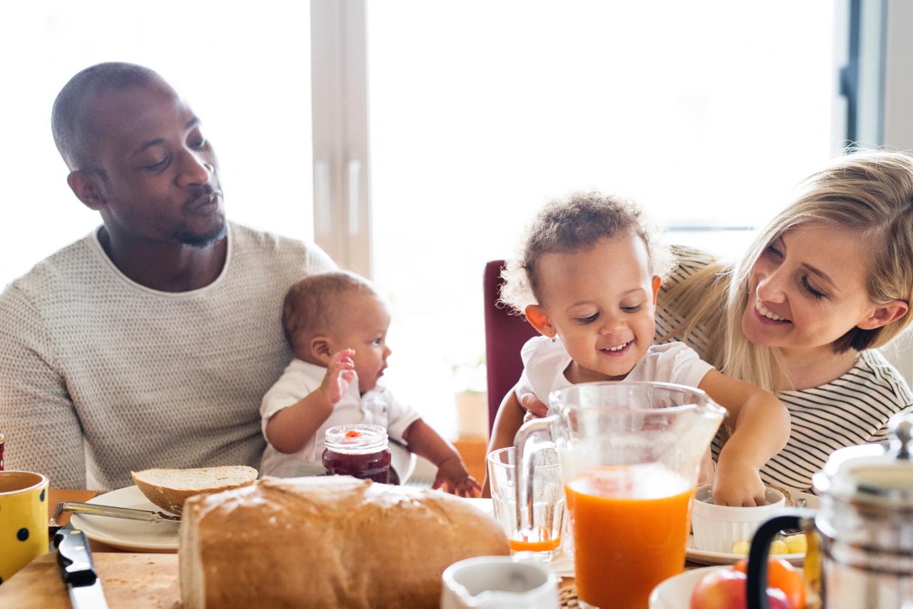 family at home with their children having breakfast together