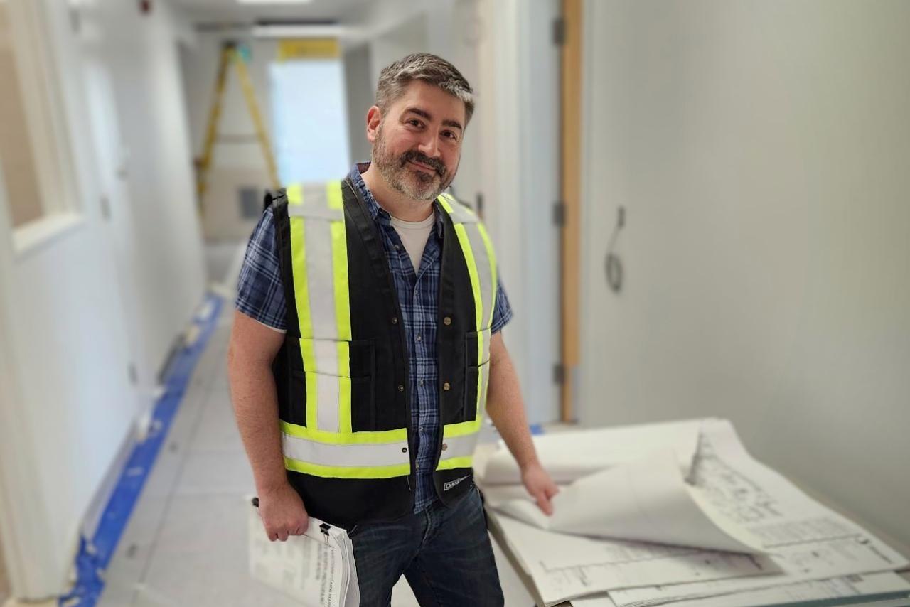 Sam McLeod standing at a work site.