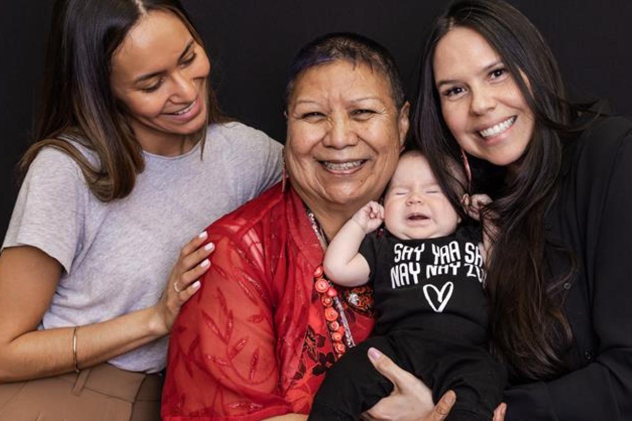 women holding a crying baby