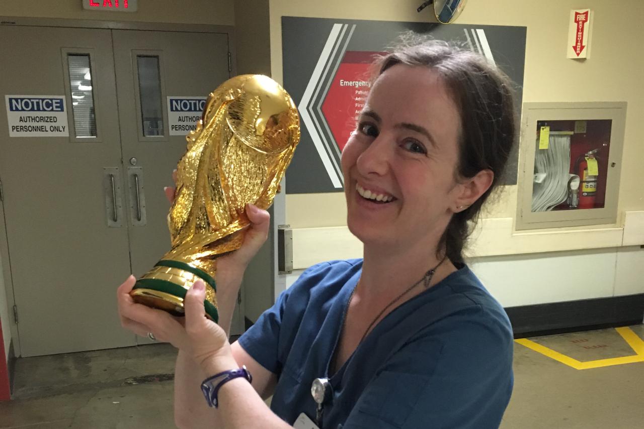 Sarah Morin, Registered Nurse, standing and holding a trophy.