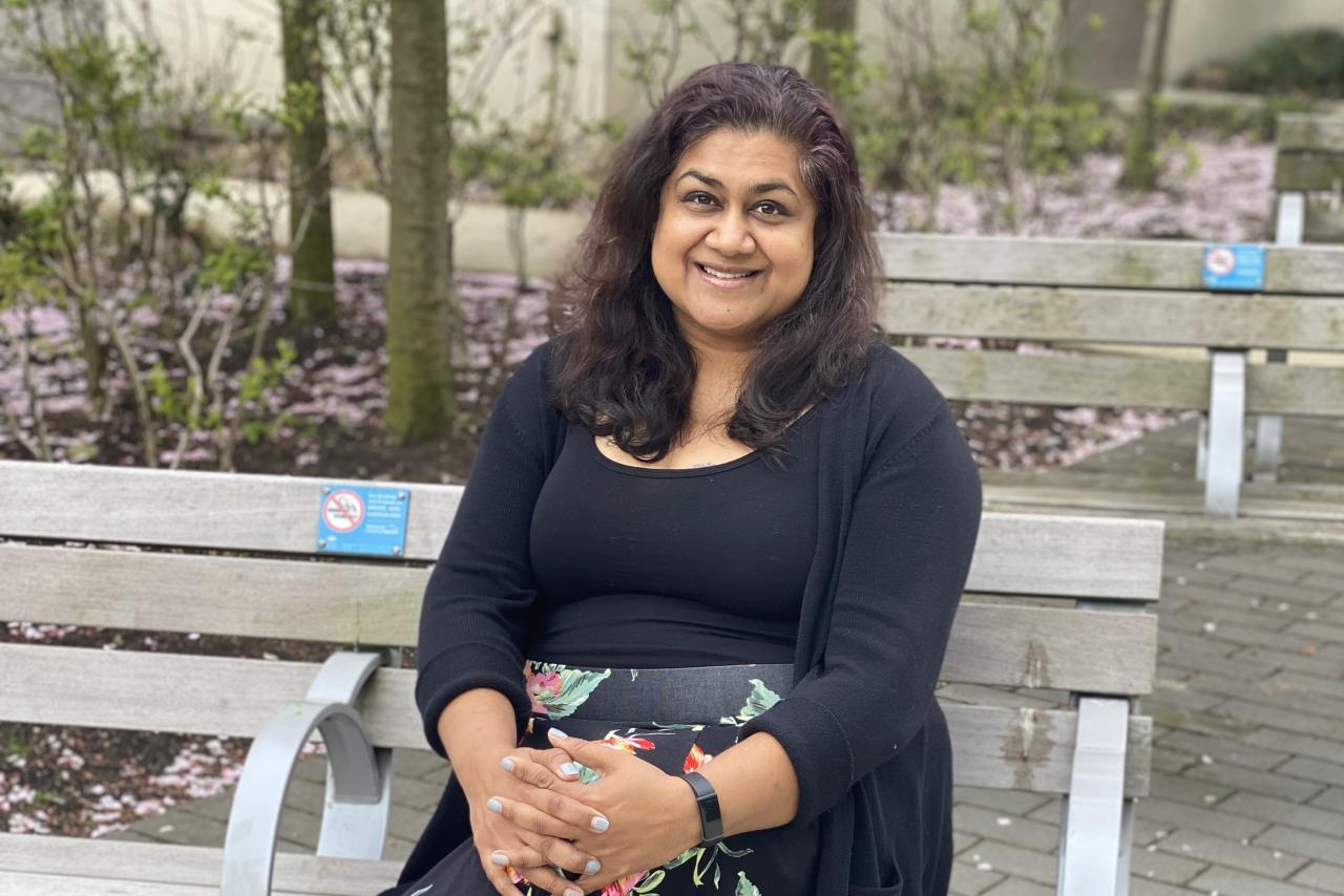 Farinah Kadir, RPN/Mental Health Nurse, sitting on a bench.