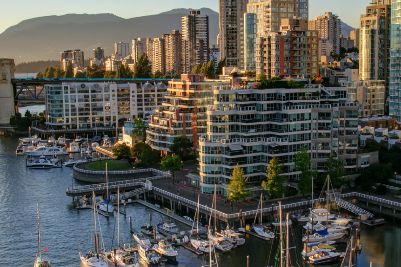 Downtown Vancouver cityscape with bridge and water.