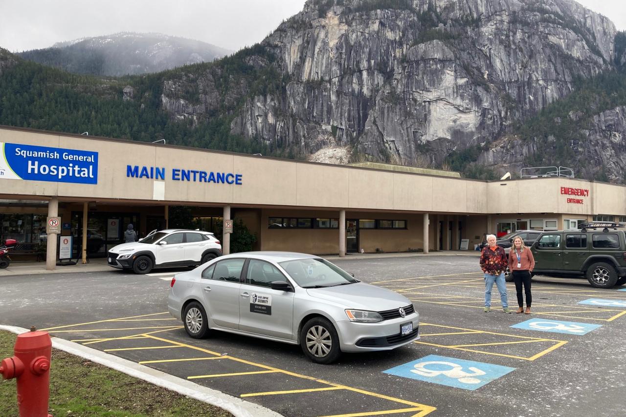 D'Arcy McCrea and Heidi Butler standing next to the new accessible parking spaces at Squamish General Hospital