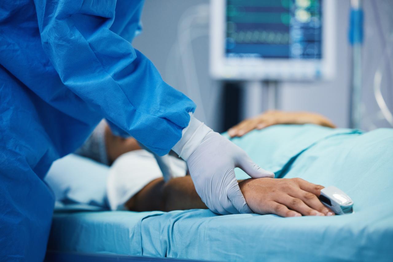 Physician holding patient's hand 