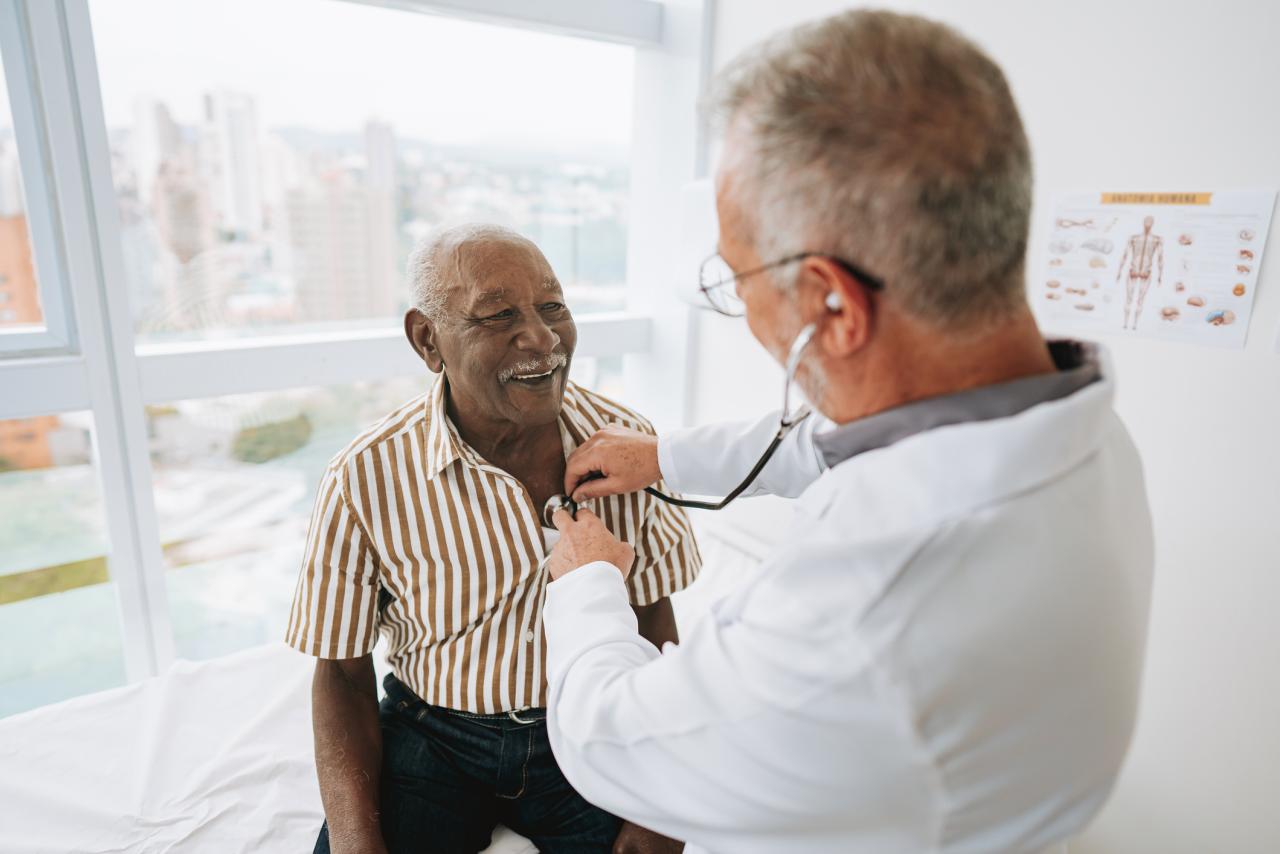 Portrait of a doctor listening to a patient's heartbeat