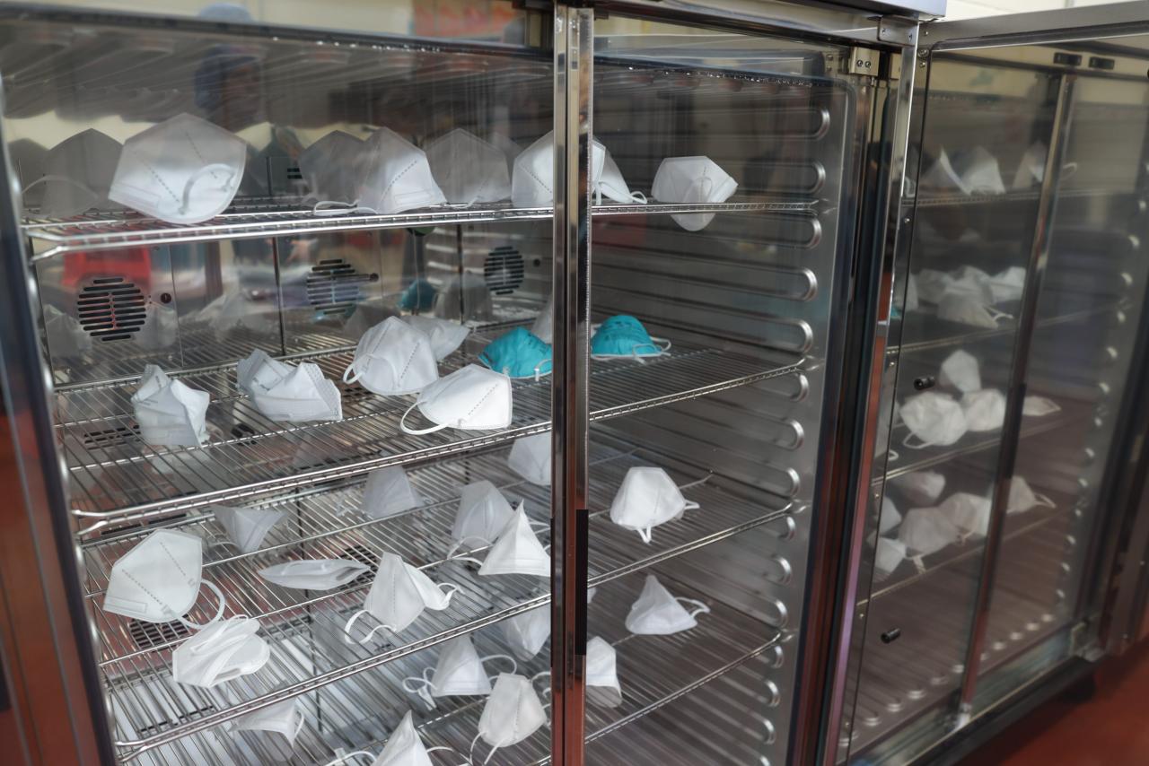 Masks inside of a glass storage cabinet