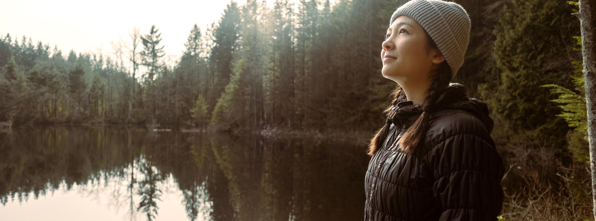 Person in quiet contemplation on the edge of a lake in North Vancouver