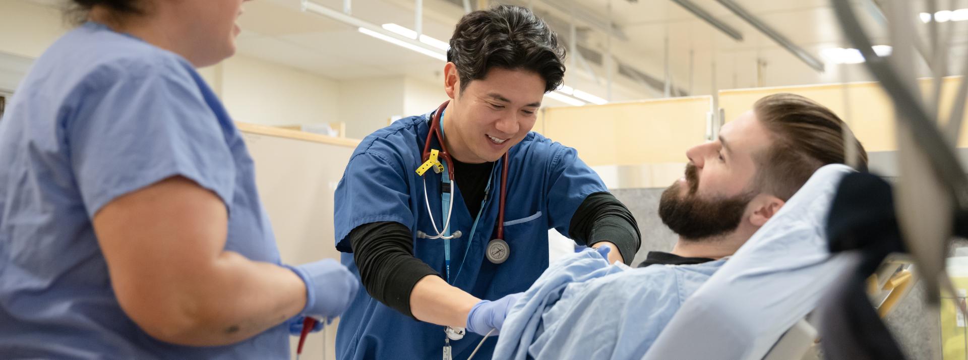 Image of a nurse and doctor assisting a patient 