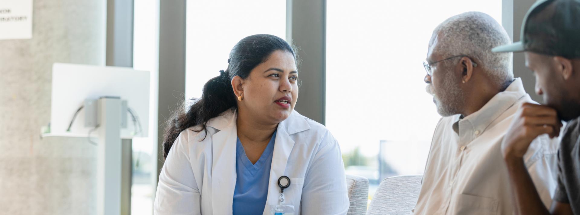 a doctor discusses medical issues with her senior adult as the support person listens in.