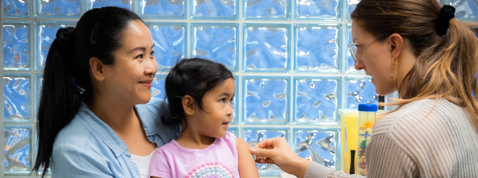 Child with parent at VCH immunization clinic.