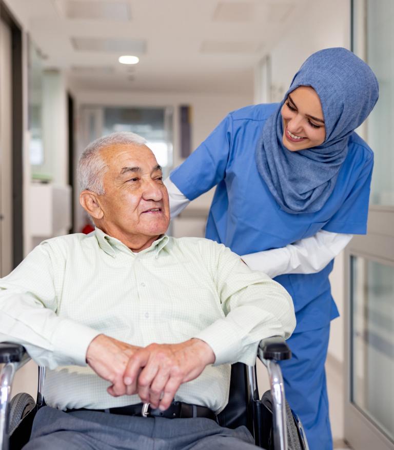 Nurse pushing a client in a wheelchair