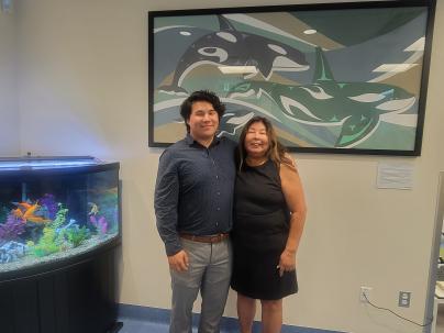 Darryl Blyth posing next to his artwork in the Richmond Hospital Cancer Care Clinic