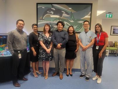 Unveiling group posing in front of the new Musqueam art piece in Cancer Care Clinic