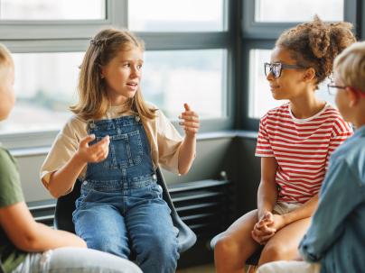 A group of children talking in a circle